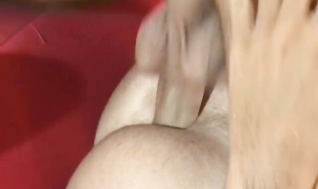 A red couch. A bare man sausage. A pipe-squashing dark-skinned-eye.