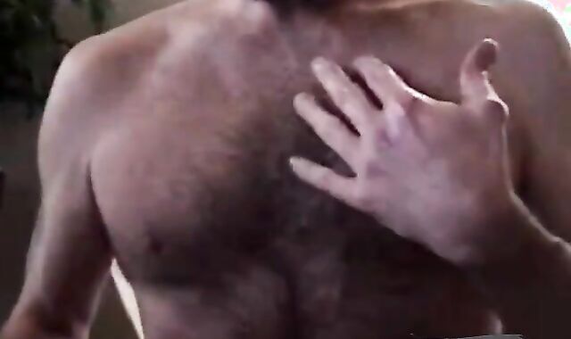 Hairy bear daddy strokes his meat