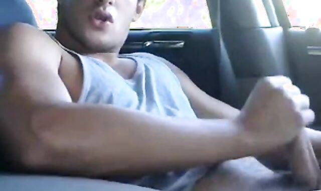 Big-cock jock strokes in his car
