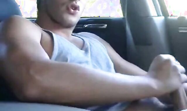 Big-cock jock strokes in his car