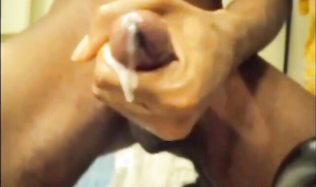 Black guy jacks off his big cock and cums hard
